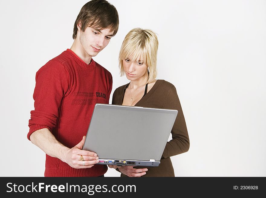 Young couple looking on the laptop screen. Young couple looking on the laptop screen
