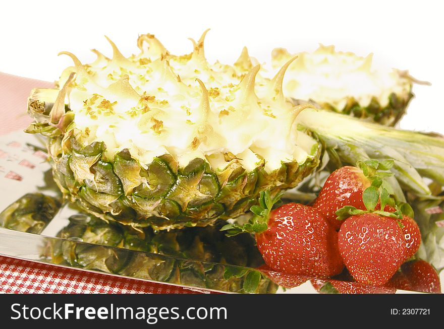 Pineapple desert with eggwhite topping and strawberries