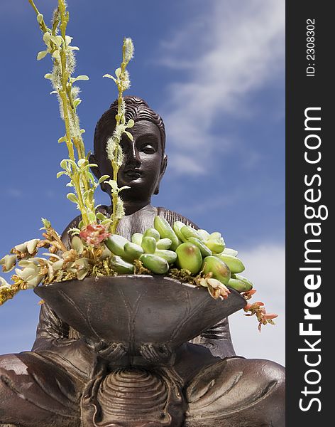 Buddha Statue set aginst beautiful blue sky.