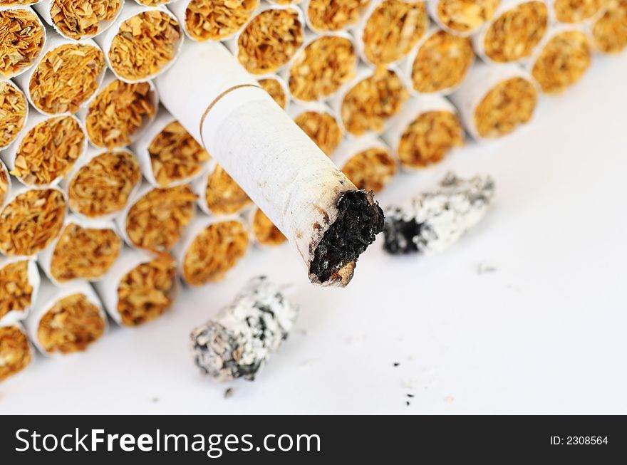 Anti smoking concept, focus on the burnt cigarette, easily converts to sepia or black and white