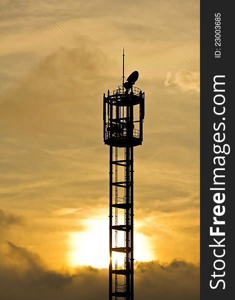 Silhouette of mobile phone antenna in orange sunset, in Japan