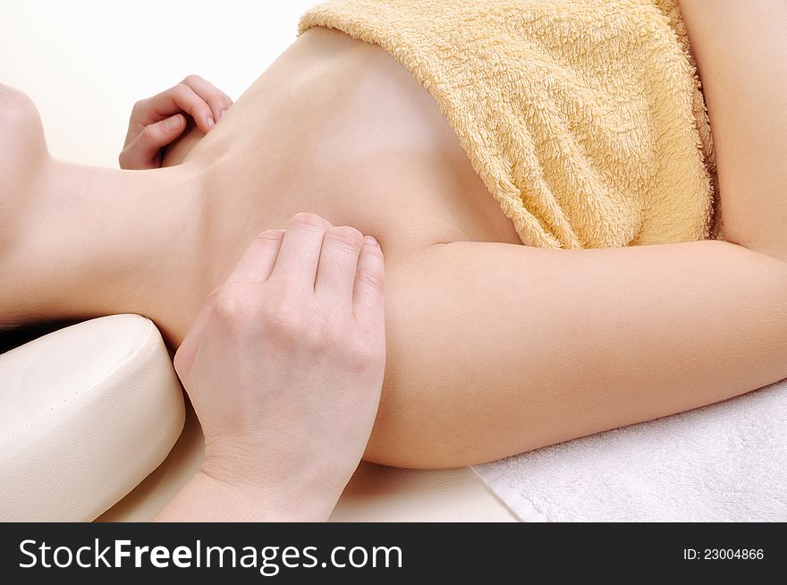 Massage the clavicle, a young woman isolated on white background