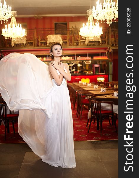 Bride in flying wedding dress in the restaurant