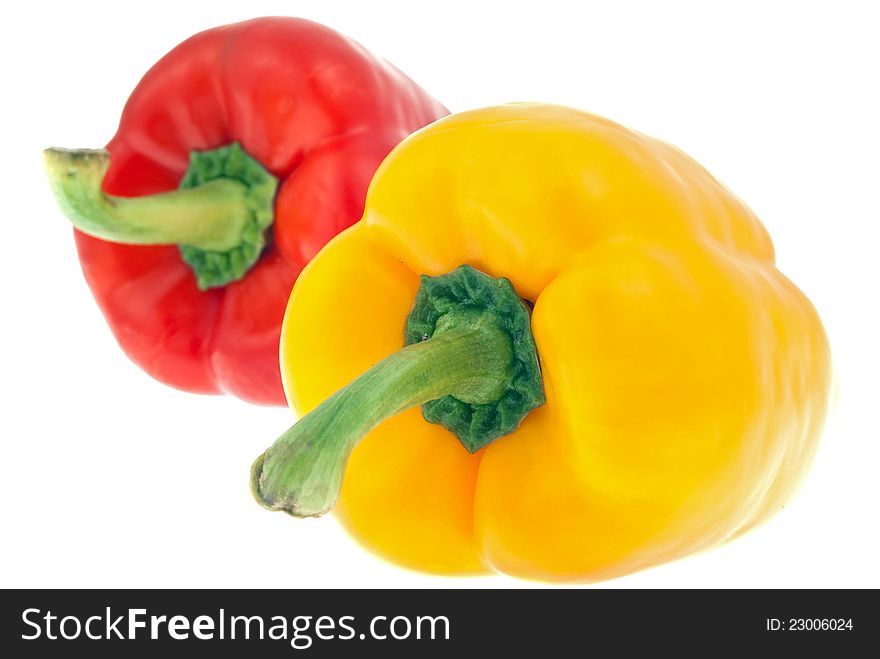 Yellow and red paprikas on the white clean background, close up