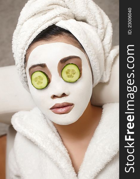 Chinese Woman with cucumbers and face mask