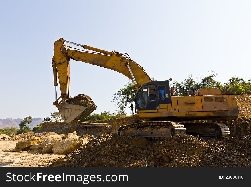 Excavator loader machine during earth moving works in mine