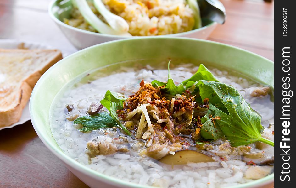 Asian style rice soup with herbs in a bowl. Asian style rice soup with herbs in a bowl