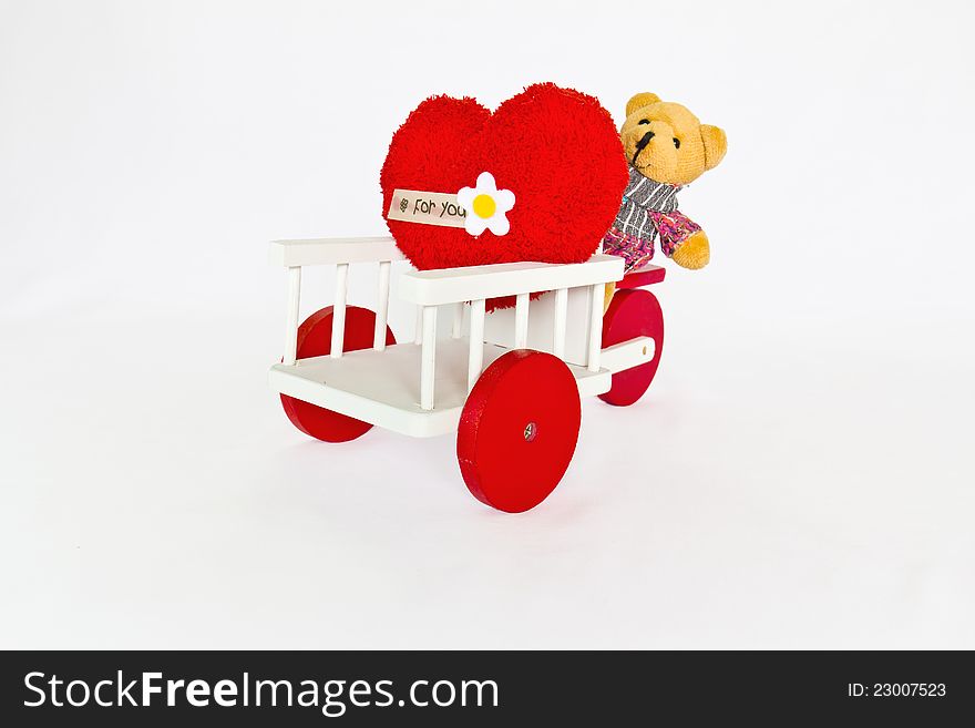 Red heart and bear on a tricycle.