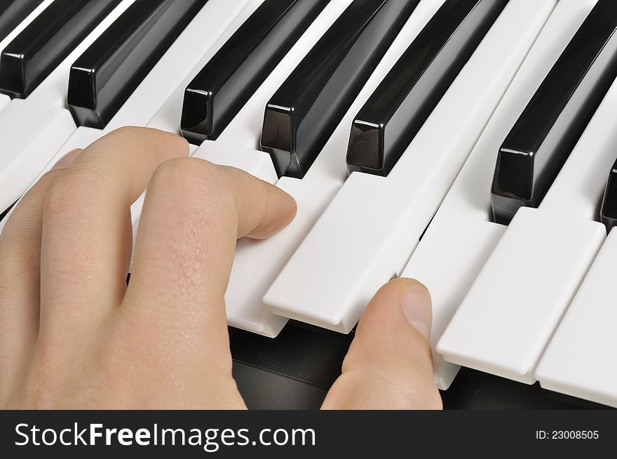 The hand of a musician playing the piano (MIDI keyboard). The hand of a musician playing the piano (MIDI keyboard)