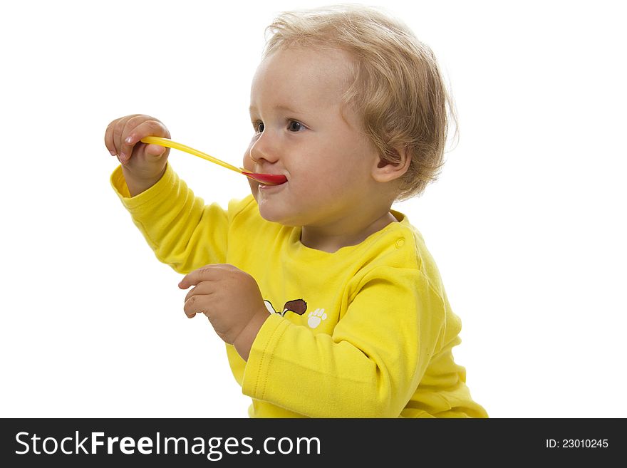 Little boy eating breakfast isolated on white.