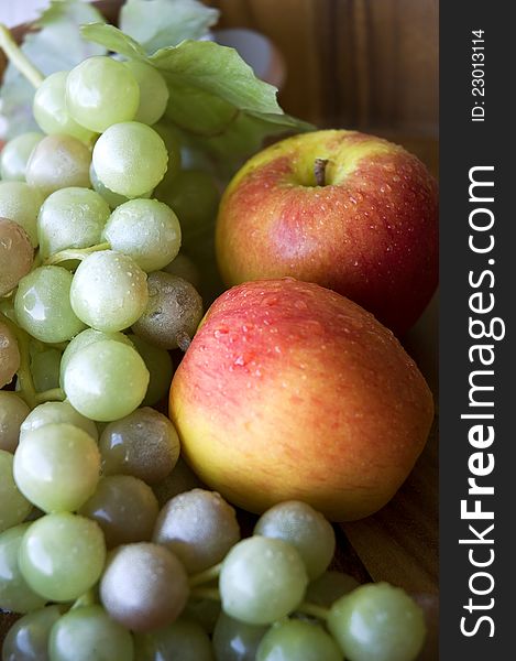 Grapes and apples put in wooden tray. Grapes and apples put in wooden tray