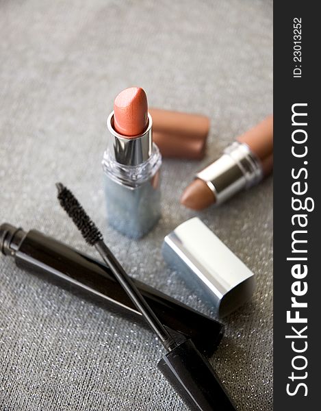 Close up red lipstick with cosmetics product background. Close up red lipstick with cosmetics product background