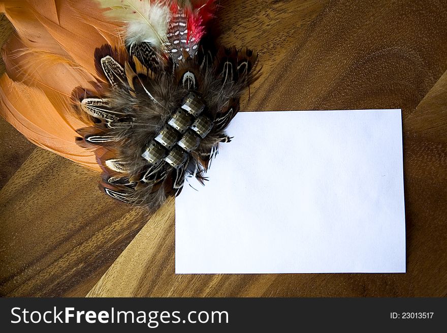 Blank white paper note decorated with orange feathers. Blank white paper note decorated with orange feathers