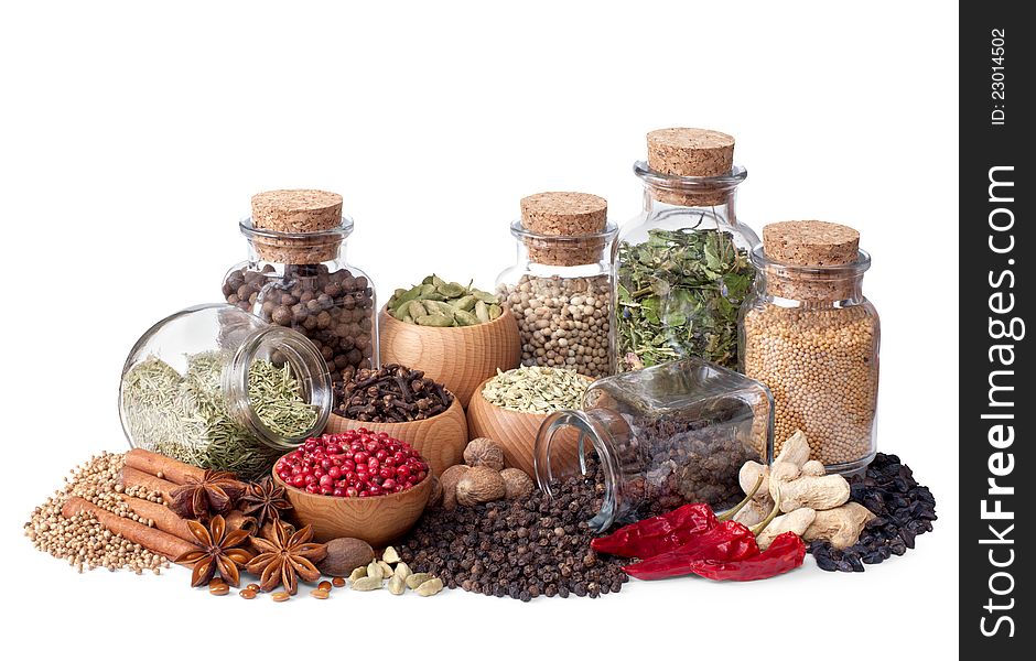 Still life of different spices and herbs on white background