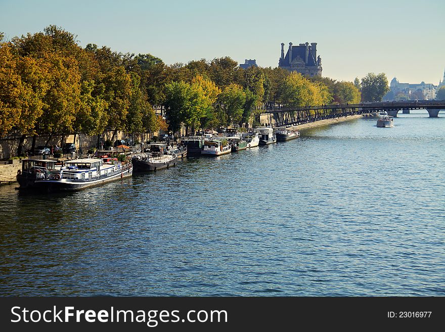 Autumn morning in Paris. Boats standing along Seine riverbank