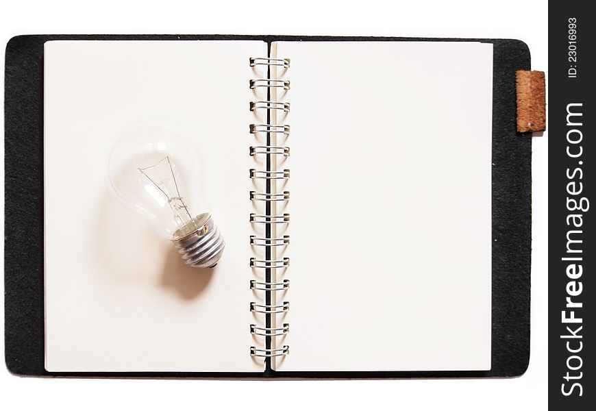 Light bulb placed on notebook