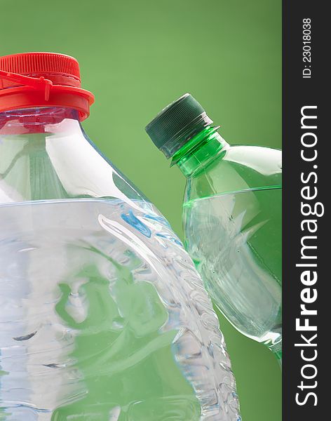 Bottled water isolated over a green background
