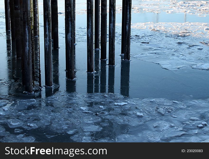 Pier pillars in icy water