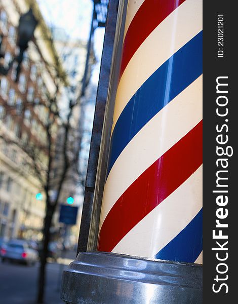 Barber pole with blurred city background