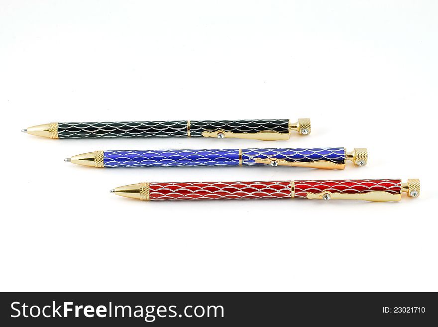Three color ballpoint pens on a white background
