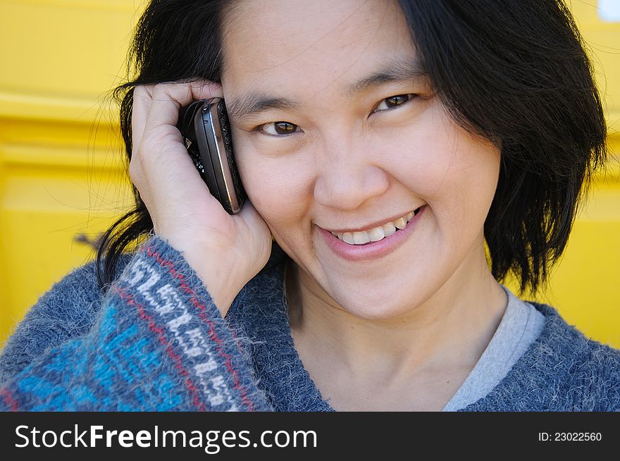 Asian girl talking on mobile phone, communication concept. Asian girl talking on mobile phone, communication concept