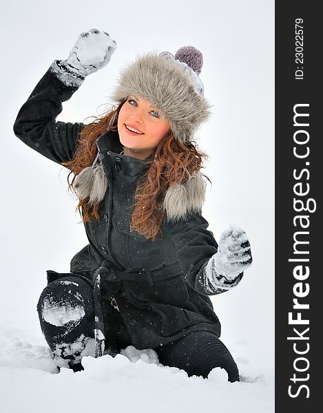 Young Beautiful Woman play with snow