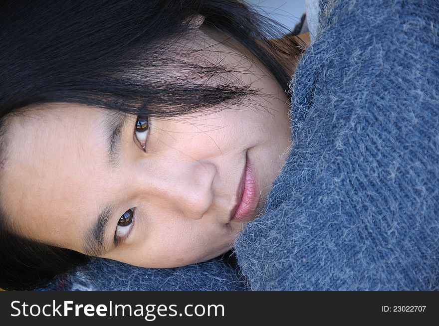 Close up of Asian woman lying down and looking at camera. Close up of Asian woman lying down and looking at camera