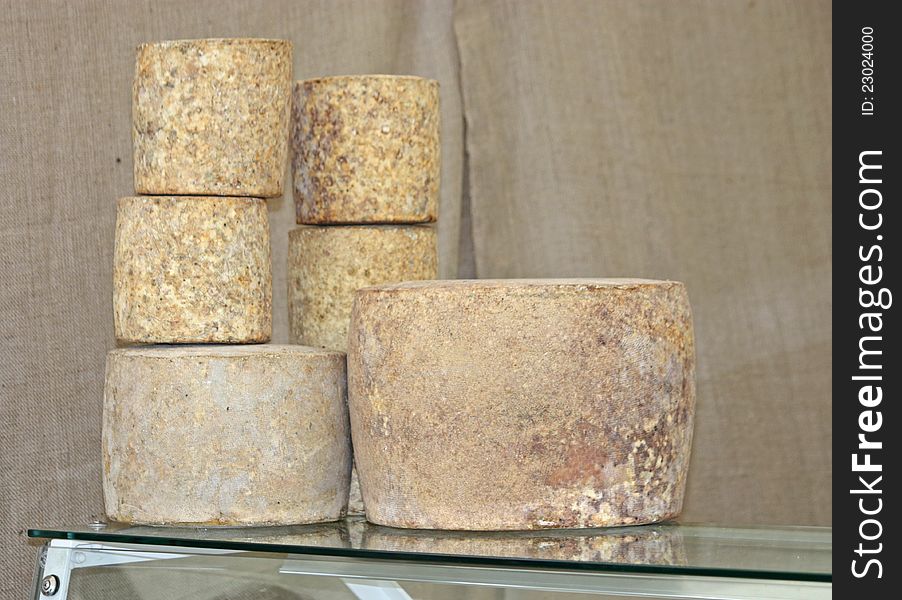 A Display of Matured Cheeses on a Glass Cabinet. A Display of Matured Cheeses on a Glass Cabinet.