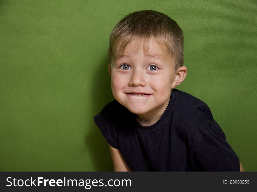 Portrait of the surprise boy on a green background. Portrait of the surprise boy on a green background