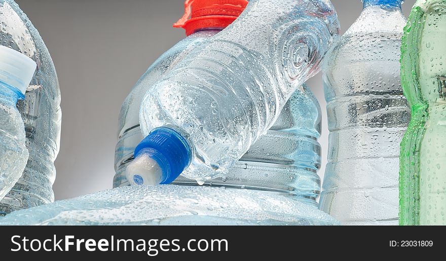 Bottled water over a grey background