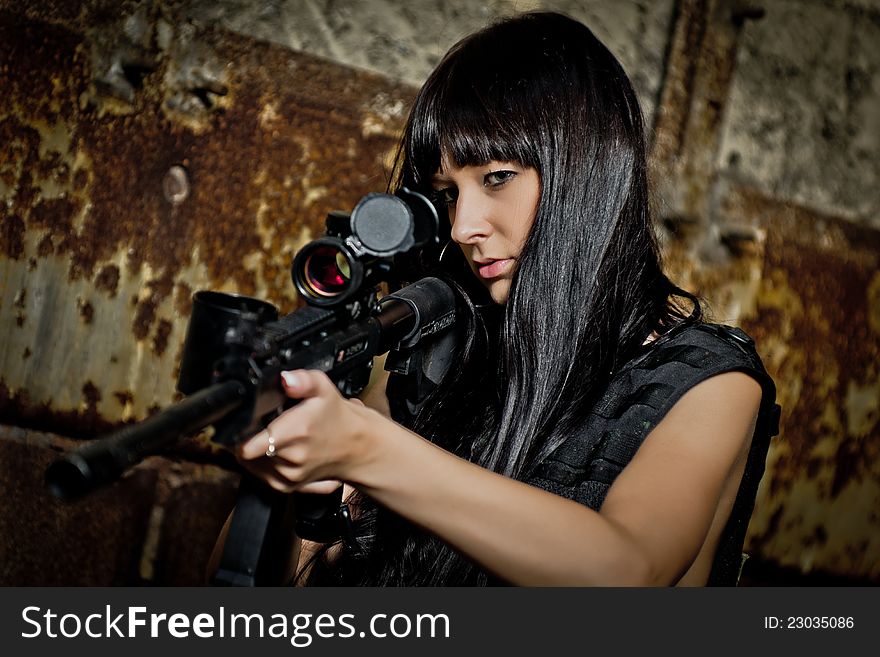 Girl in bikini with paintball markers