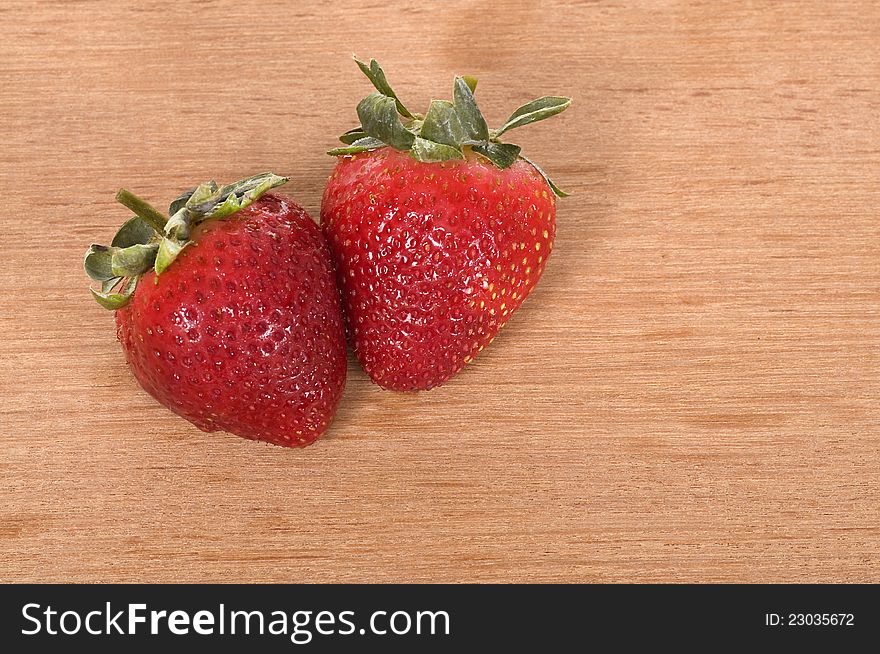 Strawberry on the wooden table. Shot in the studio