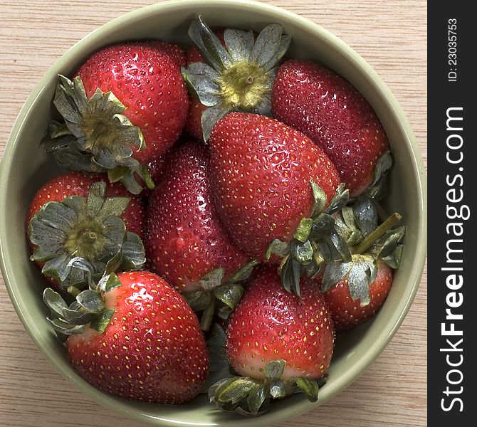 Strawberry on the bowl, good for your design. Shot on wooden background