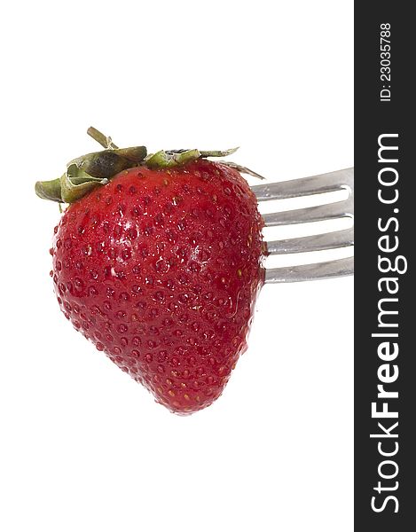 Strawberry on the fork isolated over white background. Strawberry on the fork isolated over white background