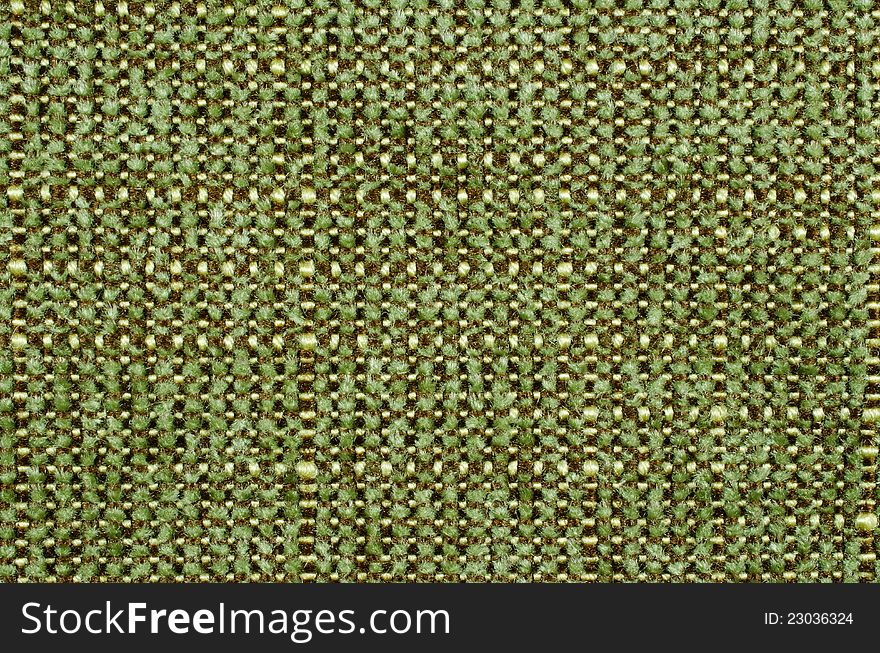 A close up photograph of a green, brown and beige fabric texture useful as a background. A close up photograph of a green, brown and beige fabric texture useful as a background.
