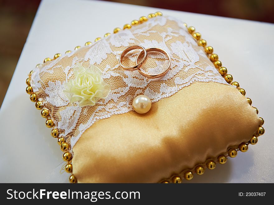 Wedding rings on a satin pillow