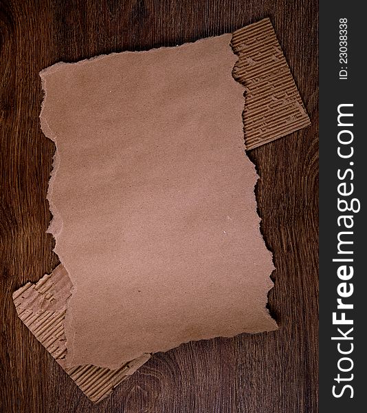 Old brown paper on the wood  background. Old brown paper on the wood  background