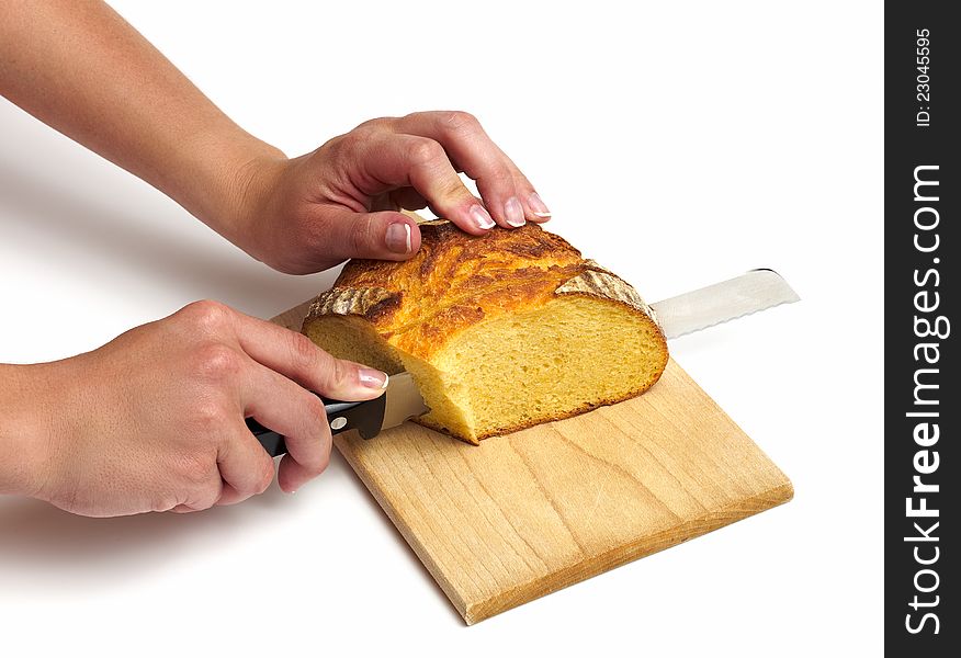 Cutting a loaf of bread on white bacground.