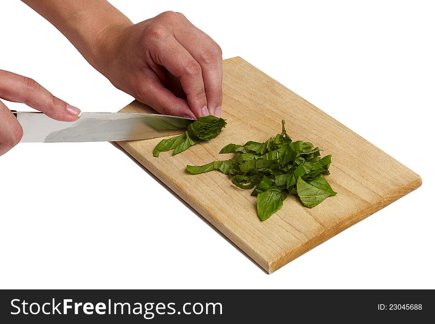 Using kitchen knife to cut Basil