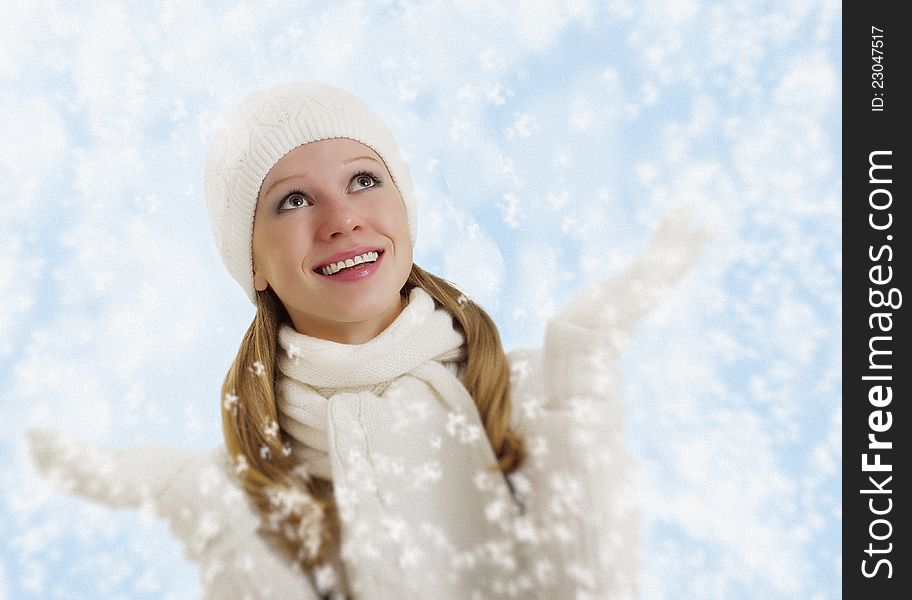 Christmas portrait of a beautiful happy girl with snowflakes on a winter background. Christmas portrait of a beautiful happy girl with snowflakes on a winter background