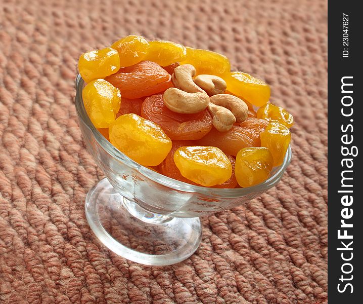 Dried apricots and lemons with cashew nuts in a vase