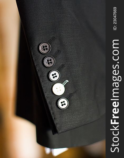 Buttons on a sleeve of a man's suit. Buttons on a sleeve of a man's suit