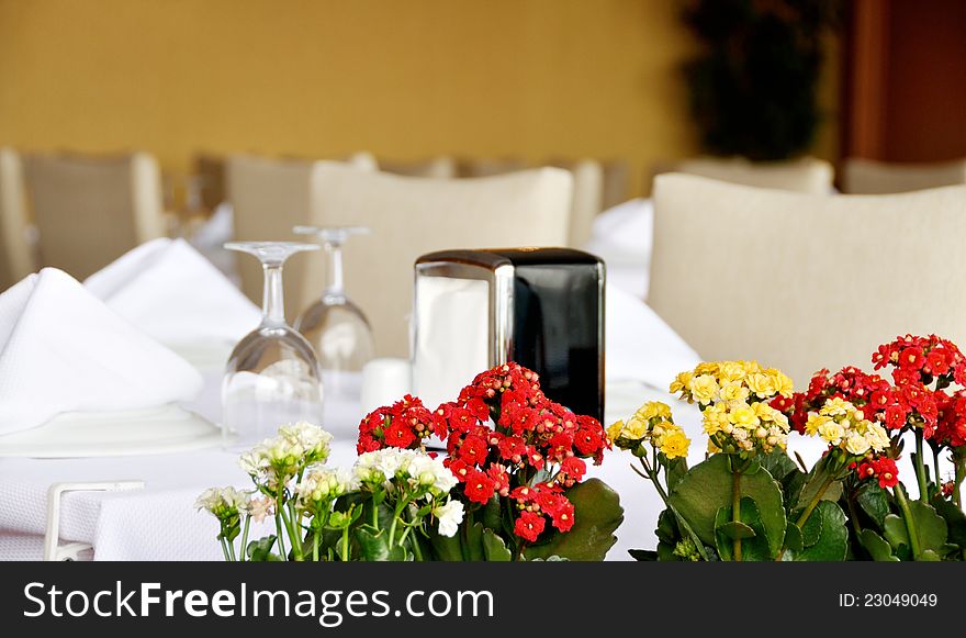 Table set served with silverware, napkin and glassware at restaurant. Table set served with silverware, napkin and glassware at restaurant