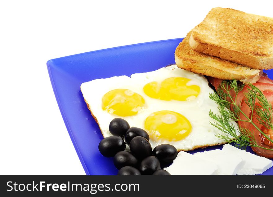 Three fried eggs , olives, cheese and toast on a blue plate. Three fried eggs , olives, cheese and toast on a blue plate