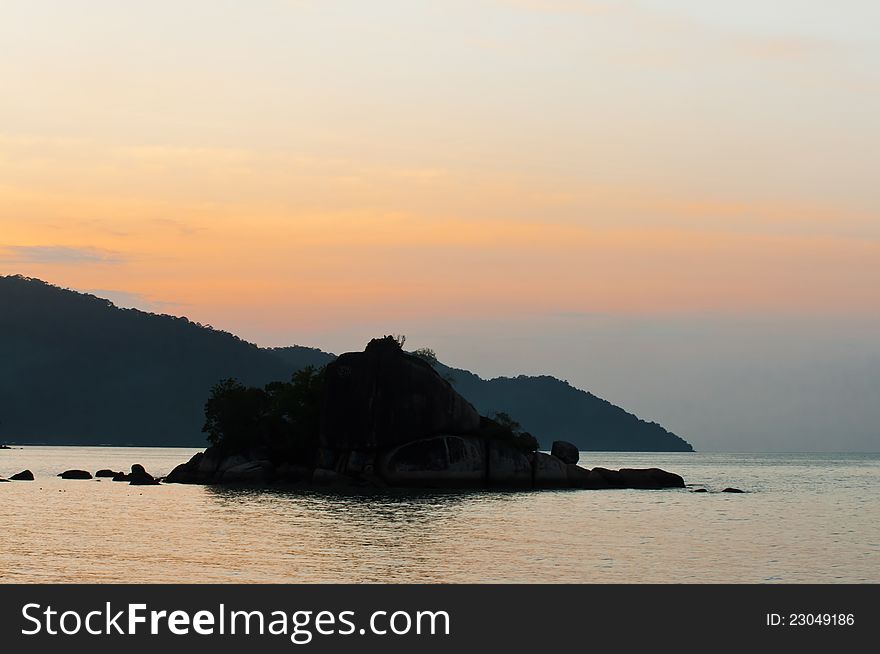 Silhouette view of small island and mountain during sunset at Feringghi beach, Penang. Silhouette view of small island and mountain during sunset at Feringghi beach, Penang