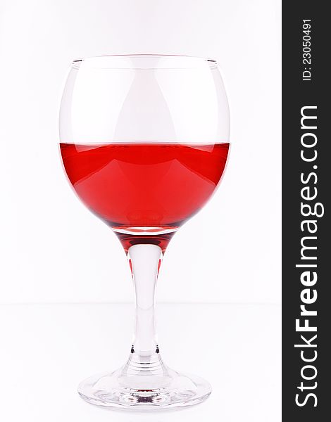 A glass of red wine on white, studio shot