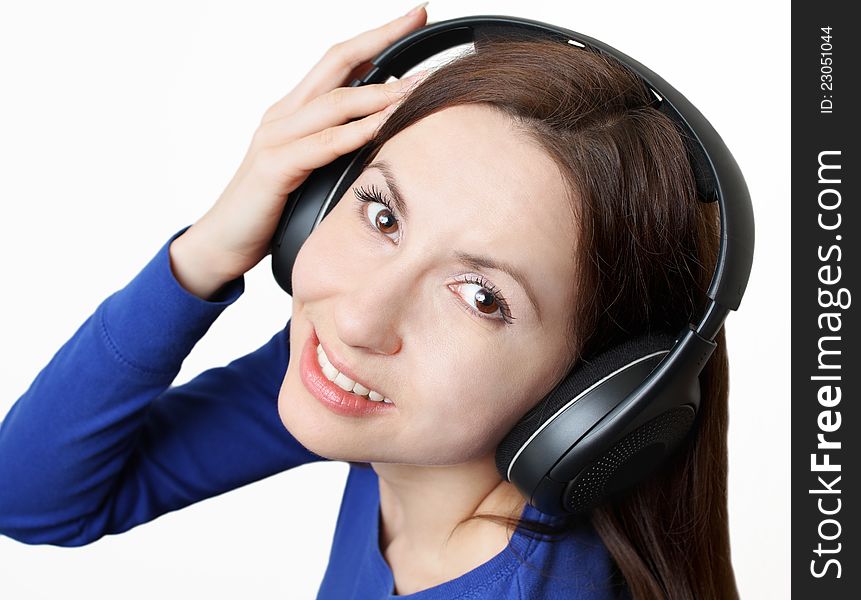 Young woman with big headphones smiling and looking up. Young woman with big headphones smiling and looking up