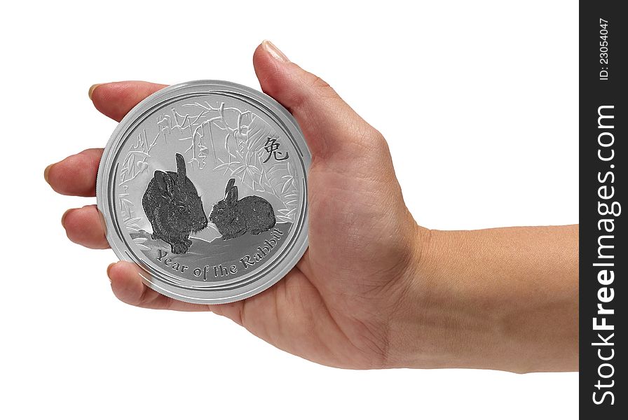 Woman having in the palm hand Year of the Rabbit silver coin.