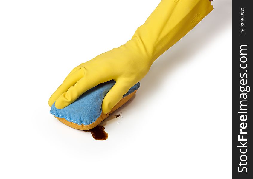 Hand in yellow glove with sponge cleaning coffe spot  on white background