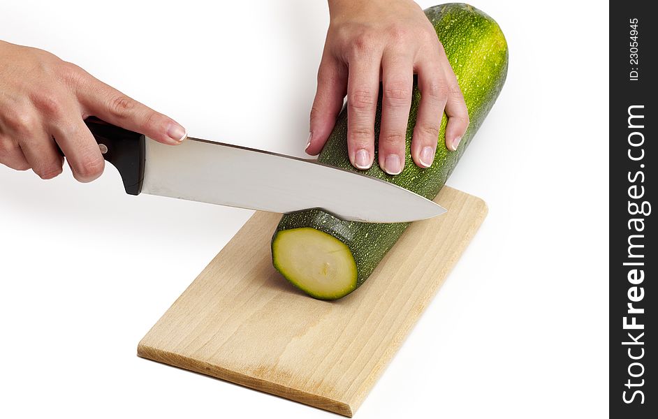 Cutting cucumber on white background.